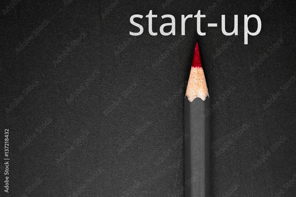 Text Start up with pencil on black background / business concept