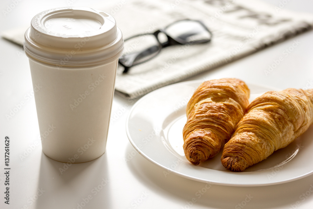 Breakfast for businessman with coffee and croissant on white table