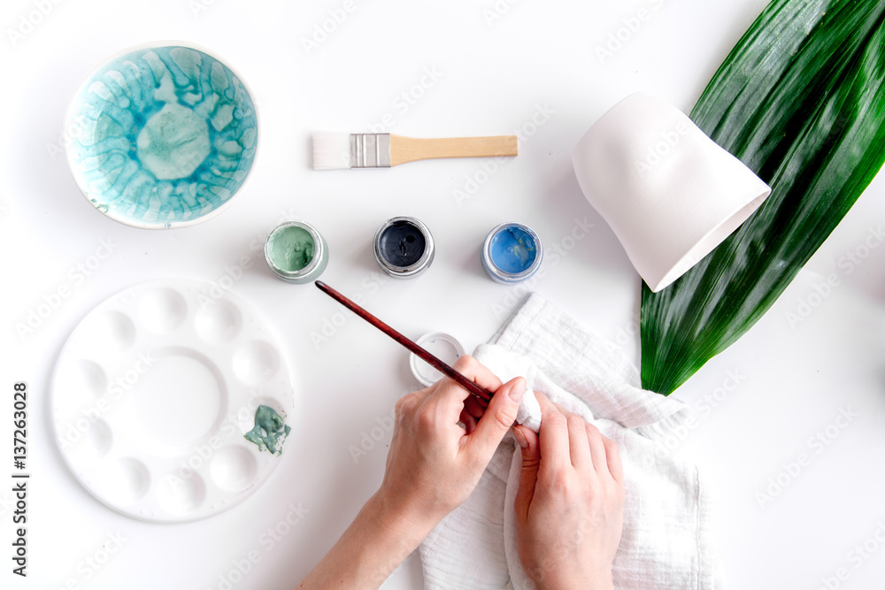 painted ceramic cup on white background top view