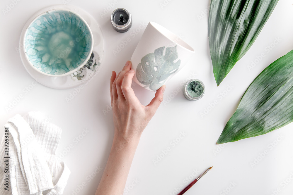 painted ceramic cup on white background top view