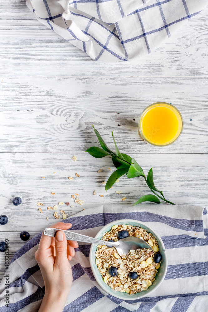 Breakfast concept with flowers on wooden background top view