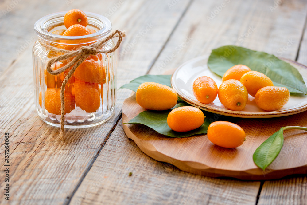 kumquat on plate at wooden table