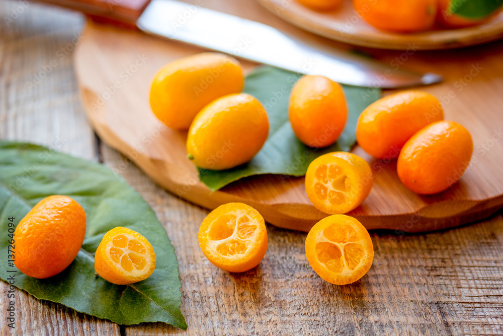 kumquat on plate at wooden table