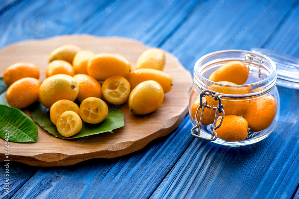 kumquat on plate at wooden table