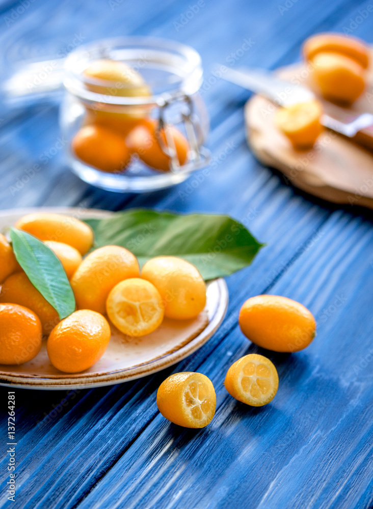 kumquat on plate at wooden table