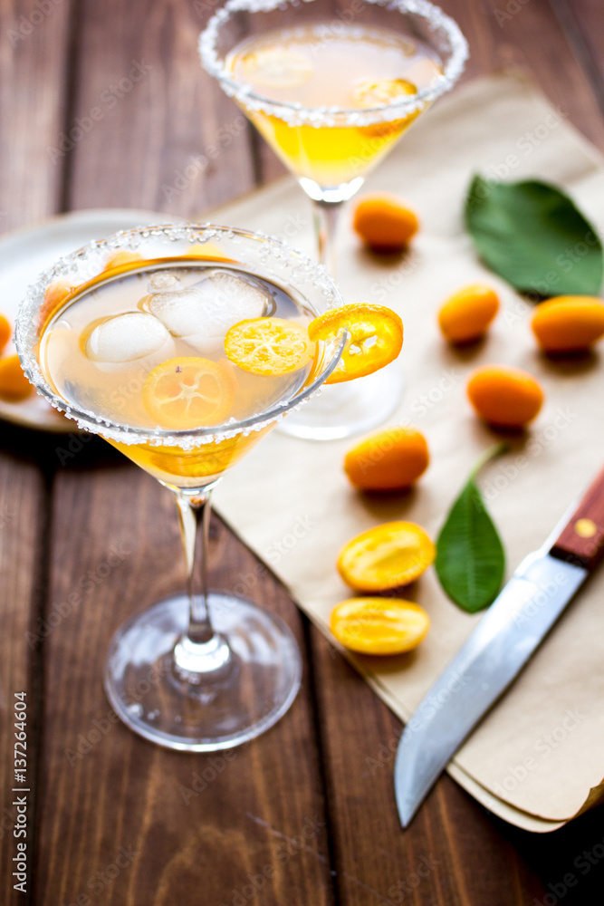 cocktail with kumquat on wooden background