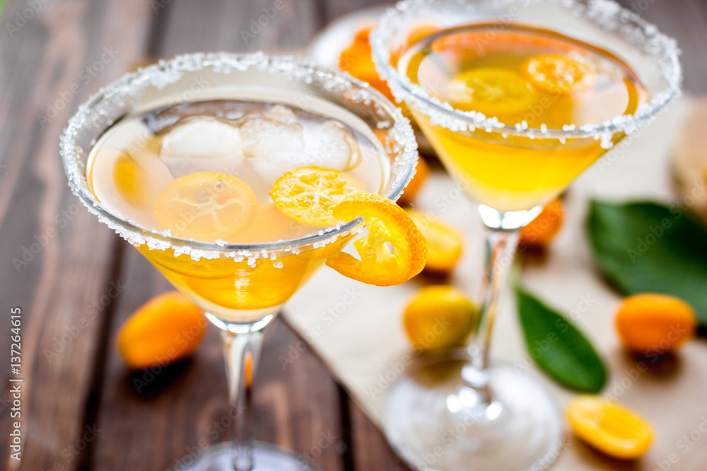 cocktail with kumquat on wooden background