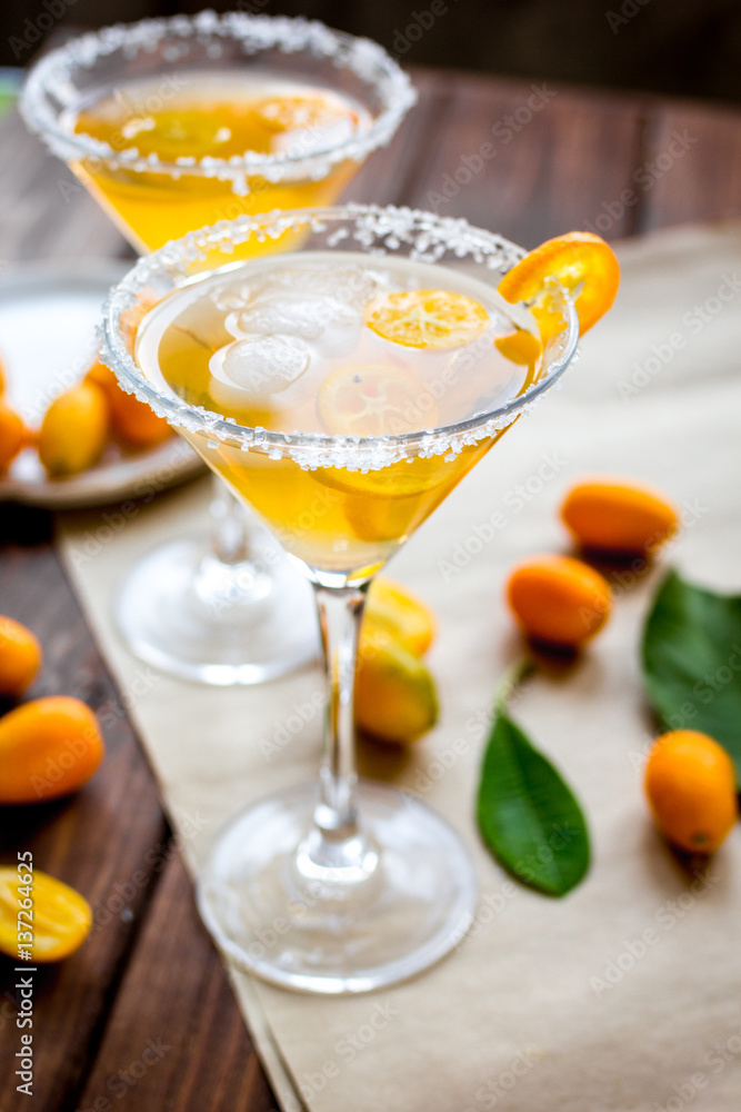 cocktail with kumquat on wooden background