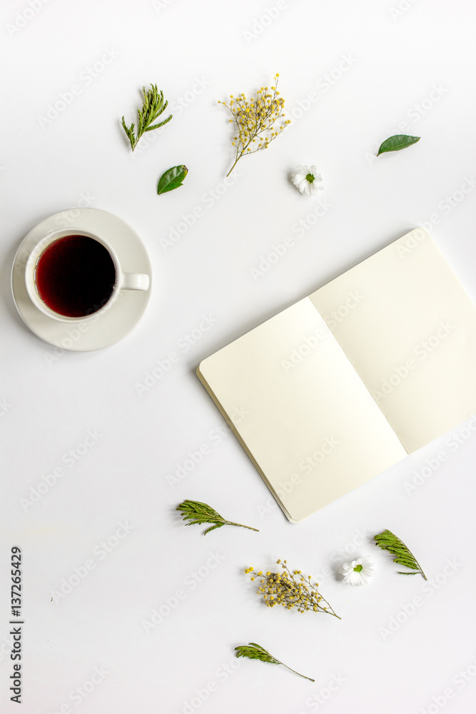 Copybook, americano and flowers on white table top view mock-up