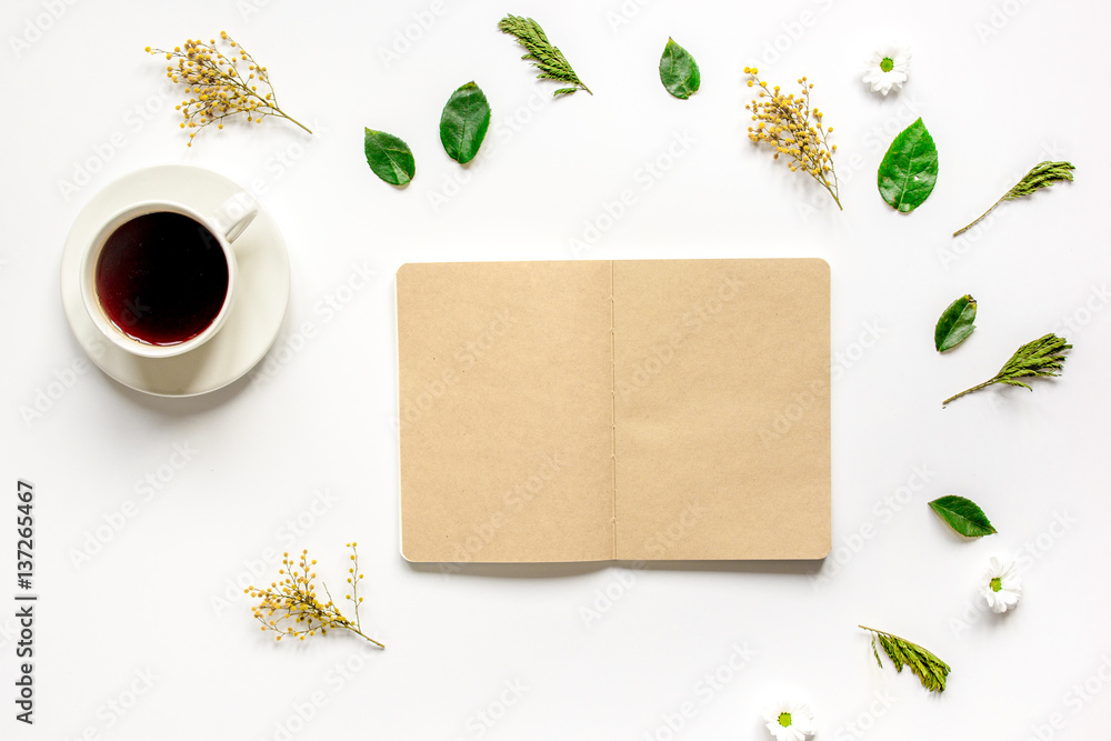 Froral flat lay with cup and notepaper top view mockup