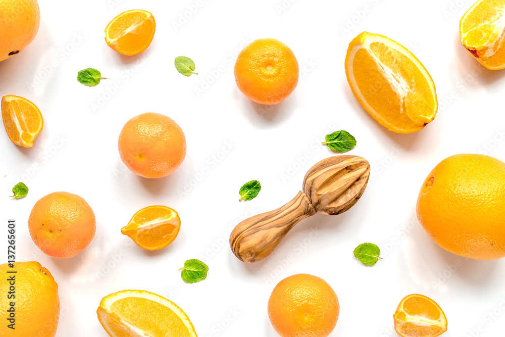 Cut oranges for juicy breakfast on white background top view pattern