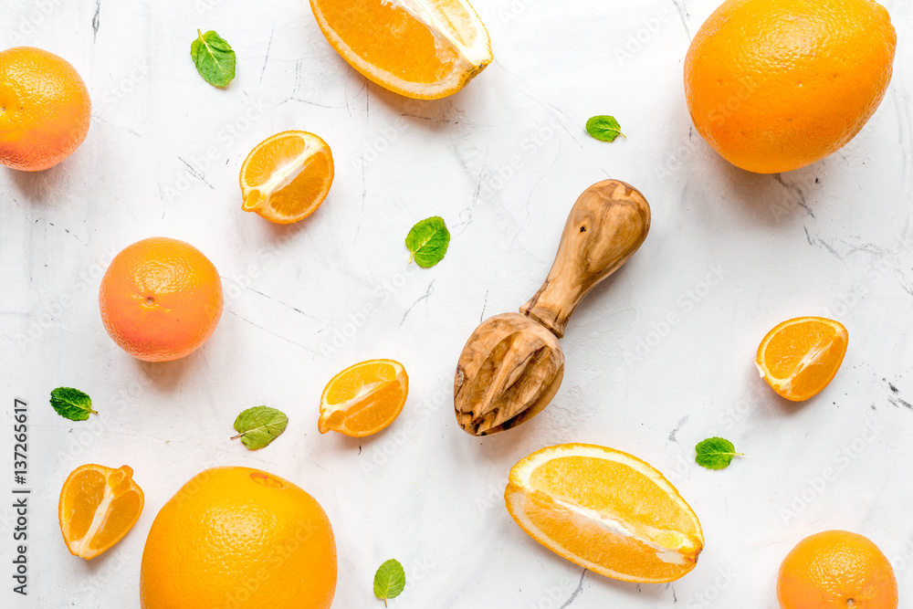 Fresh orange fruits with mint on table background top view pattern