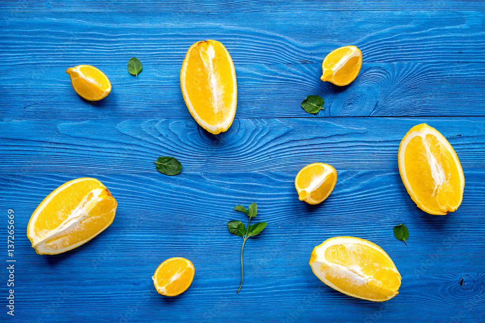 Making orange juice with mint on desk background top view pattern