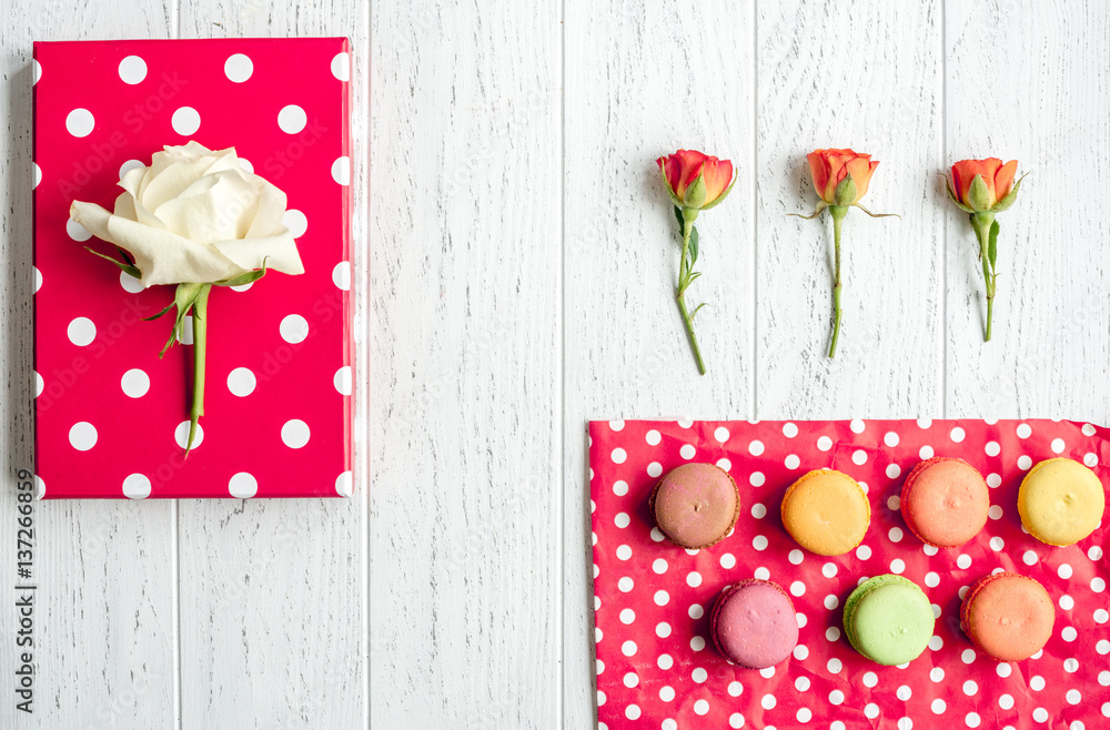 flowers and macaroon on wooden background top view pattern