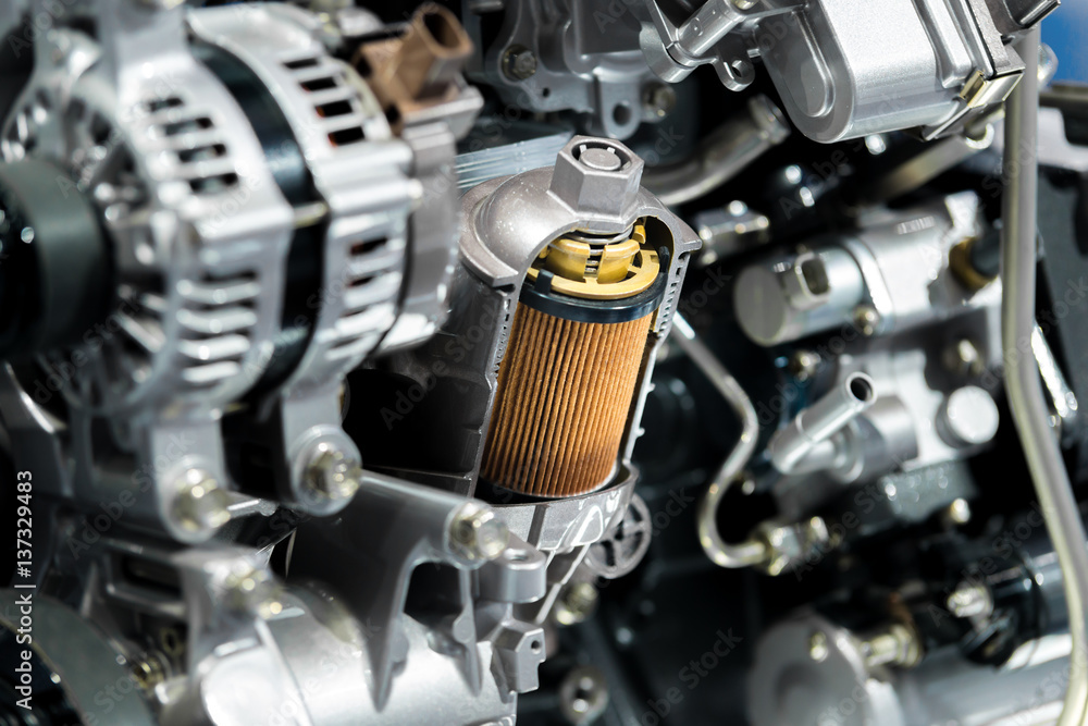 Engine oil filter cross section display inside machine motor in car.