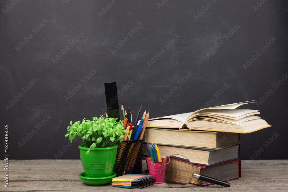 Education concept - books on the desk in the auditorium