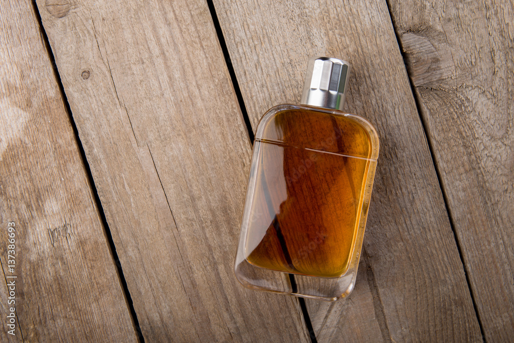 perfume bottle on the wooden background