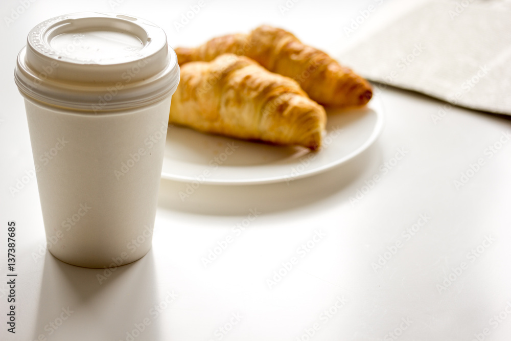 Breakfast for businessman with coffee and croissant on white table