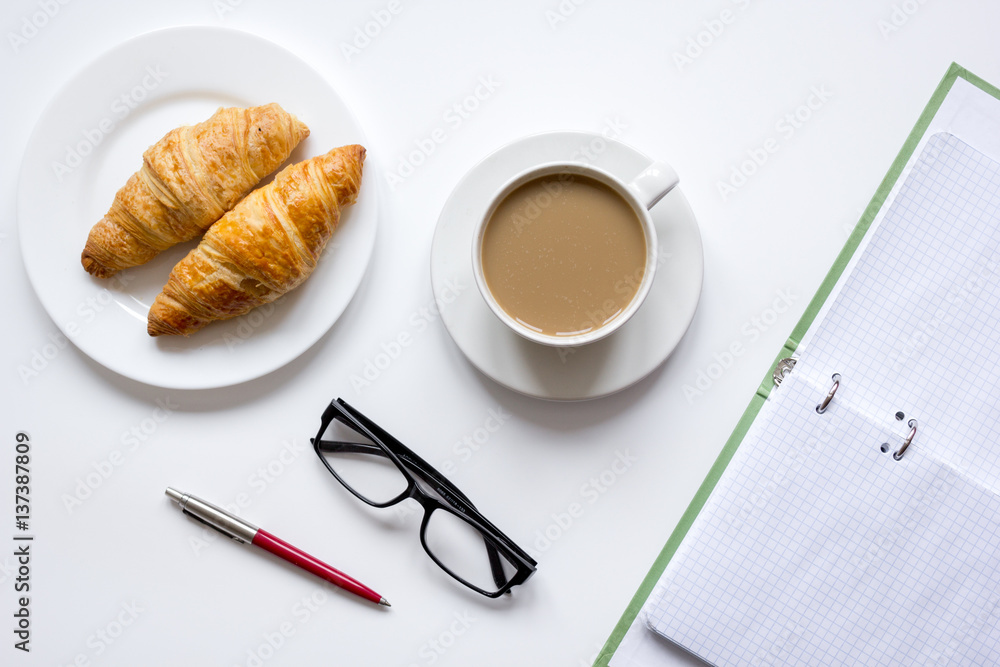 Business lunch with croissant on white table top view