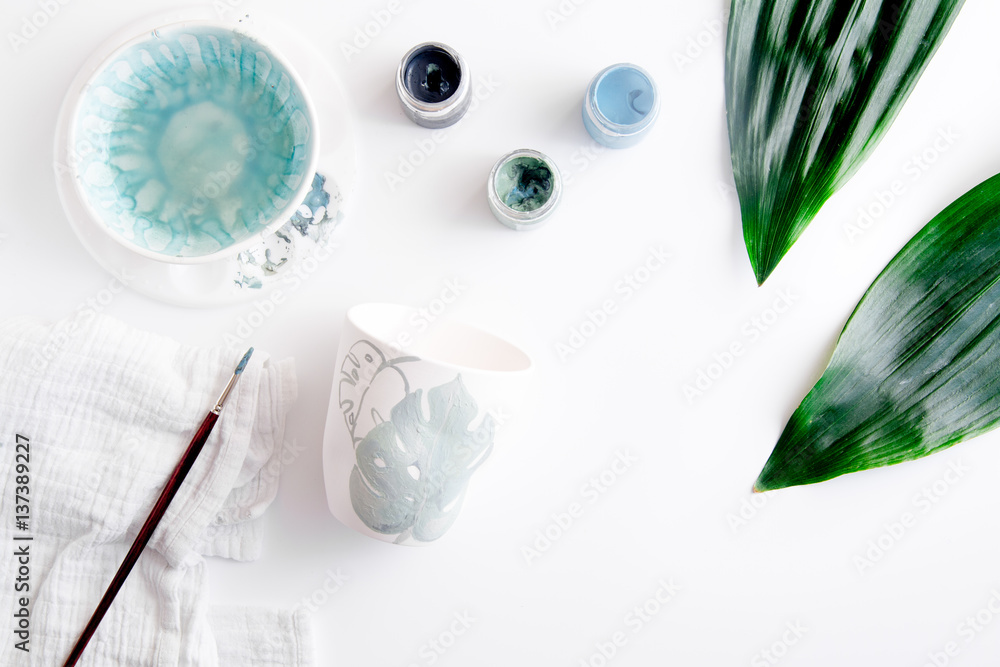 painted ceramic cup on white background top view