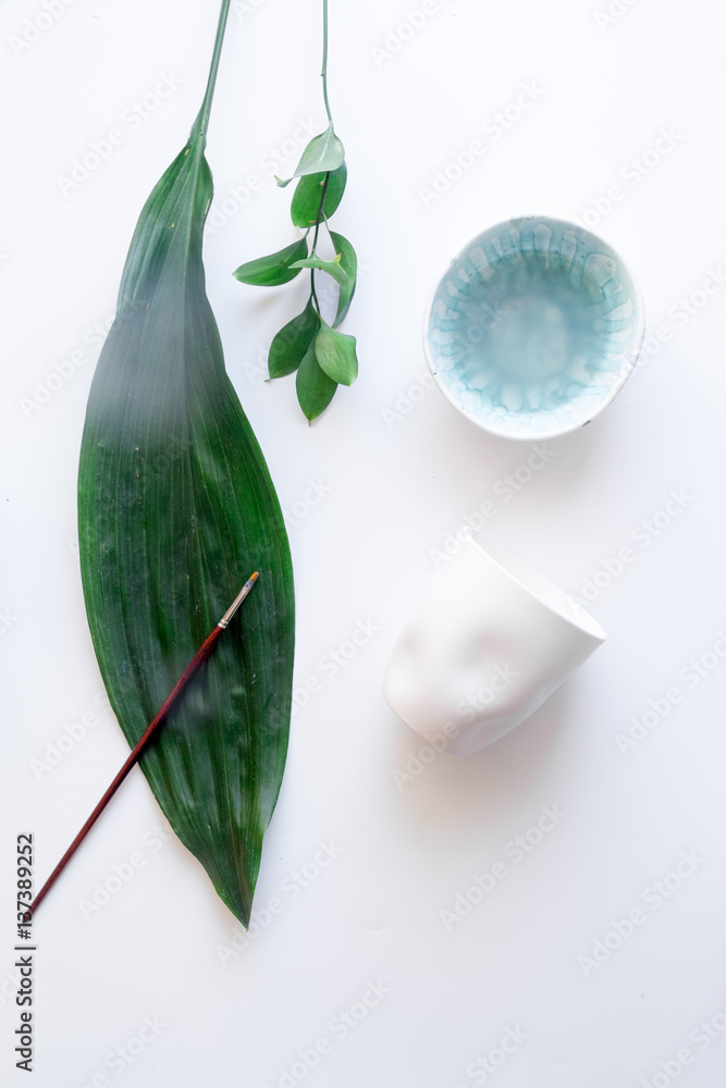 painted ceramic cup on white background top view