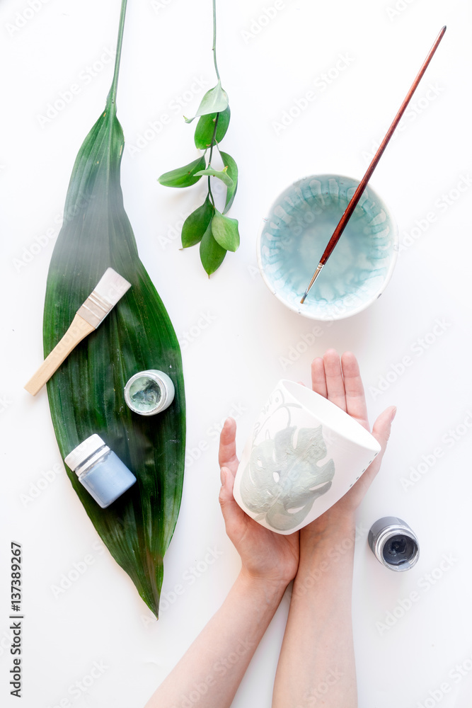 painted ceramic cup on white background top view