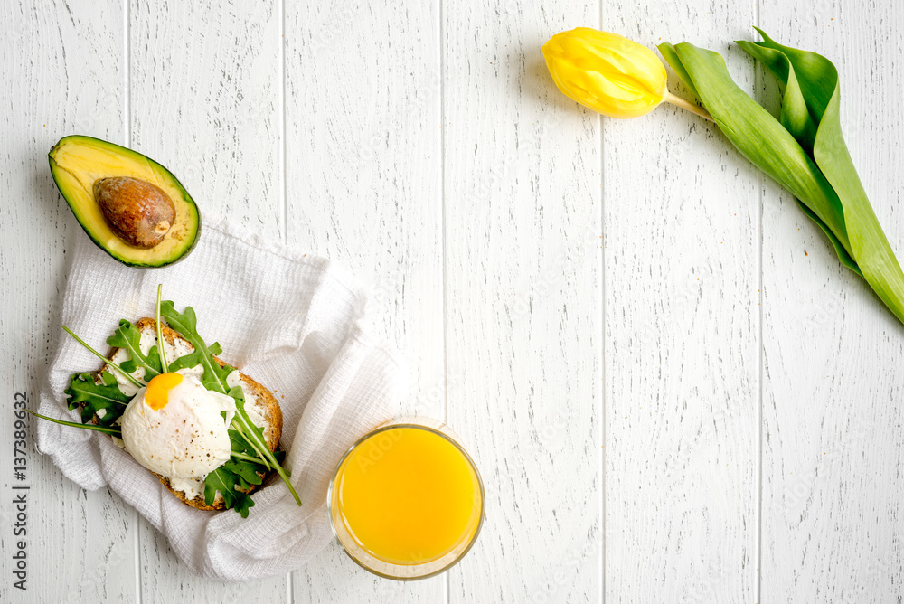 sandwich with poached eggs on wooden background top view mockup