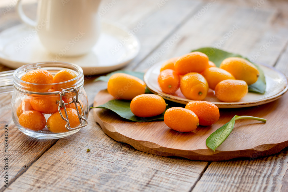 kumquat on plate at wooden table