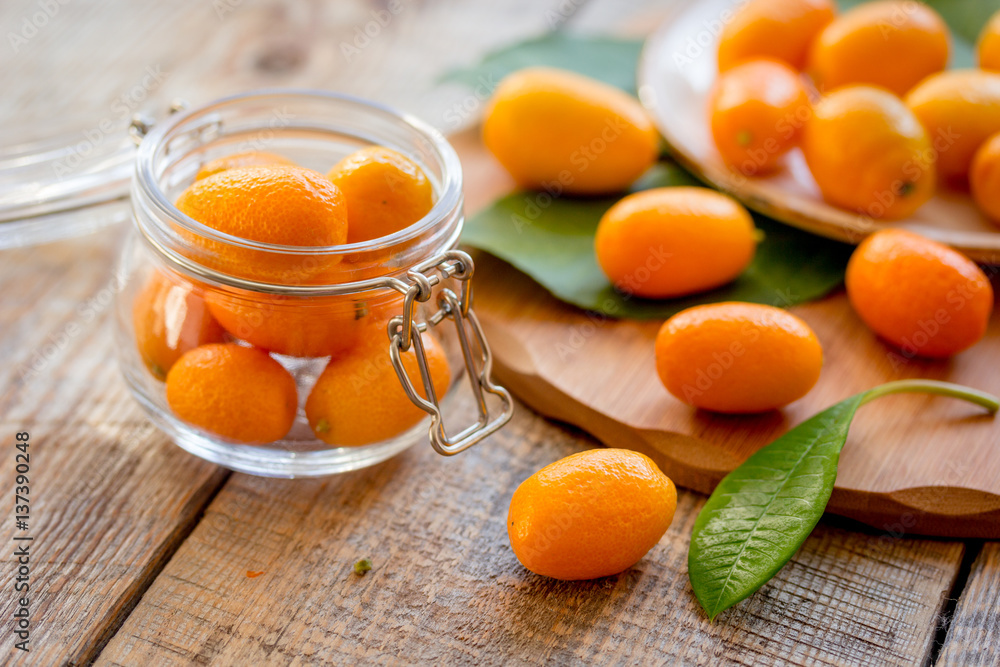 kumquat on plate at wooden table