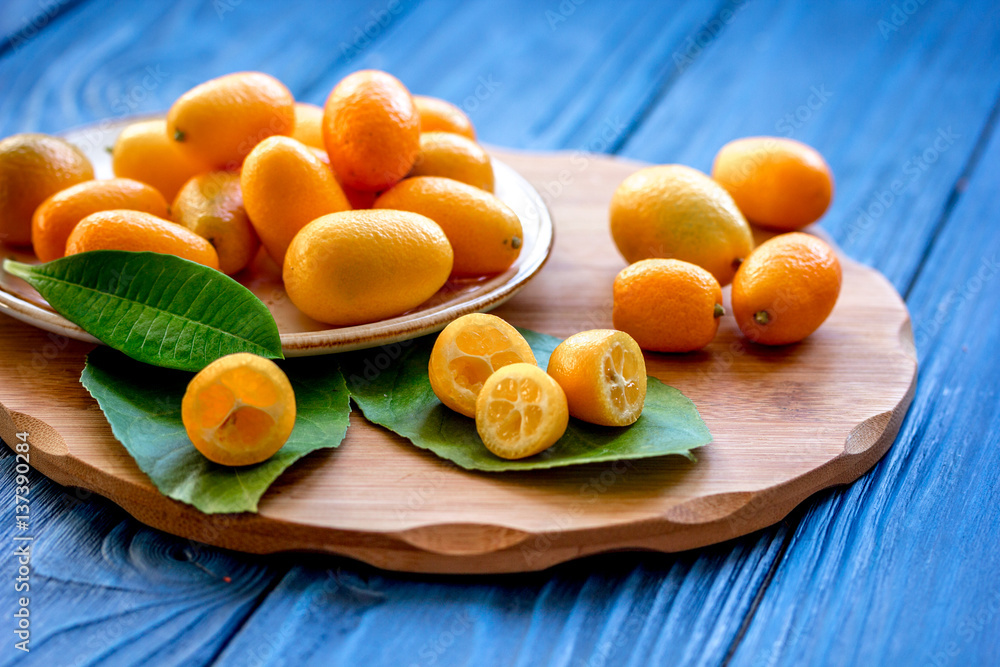 kumquat on plate at wooden table