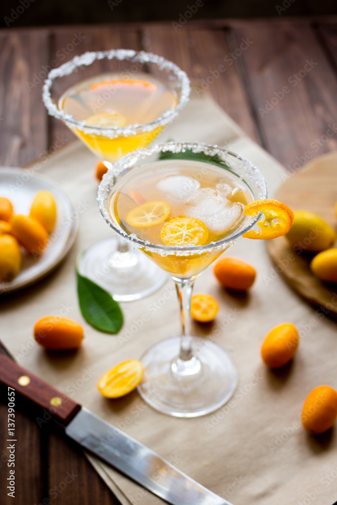 cocktail with kumquat on wooden background