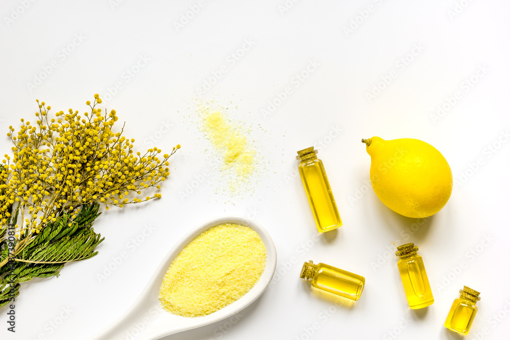 Cosmetic salt with oils and lemon white background top view mock-up