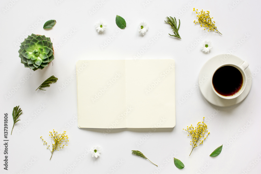 Notebook with cup of coffee on white background top view mockup