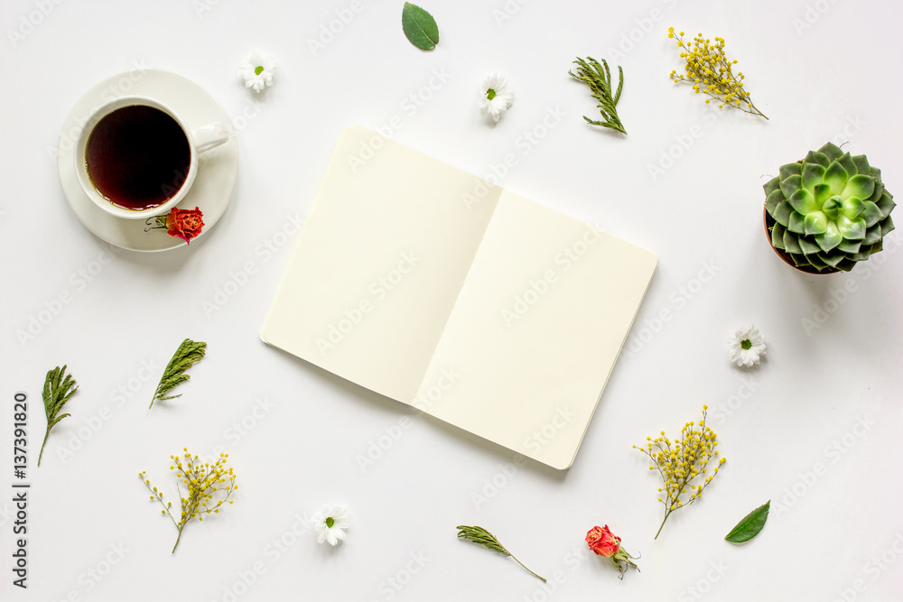 Notebook with cup of coffee on white background top view mockup