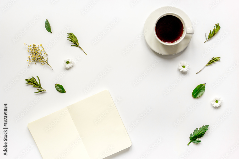 Copybook, americano and flowers on white table top view mock-up