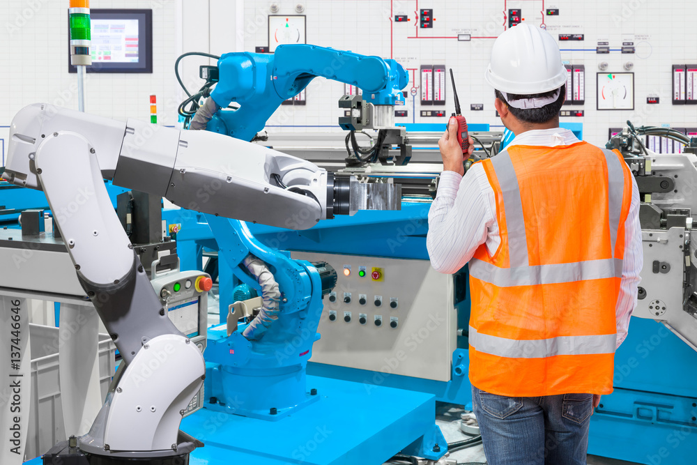 Maintenance engineer control automatic robotic hand machine tool at industrial manufacture factory