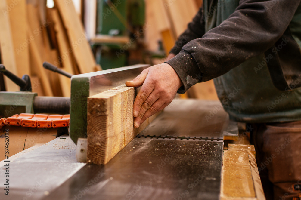 Carpenter working in a dusty workshop