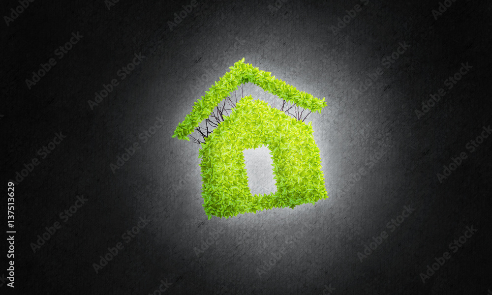 Concept of eco architecture presented by green house on dark background