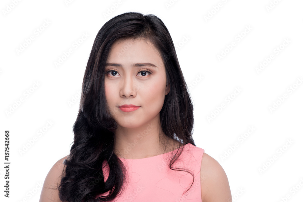 Asian young beautiful woman with long black hair in pink dress standing over white.