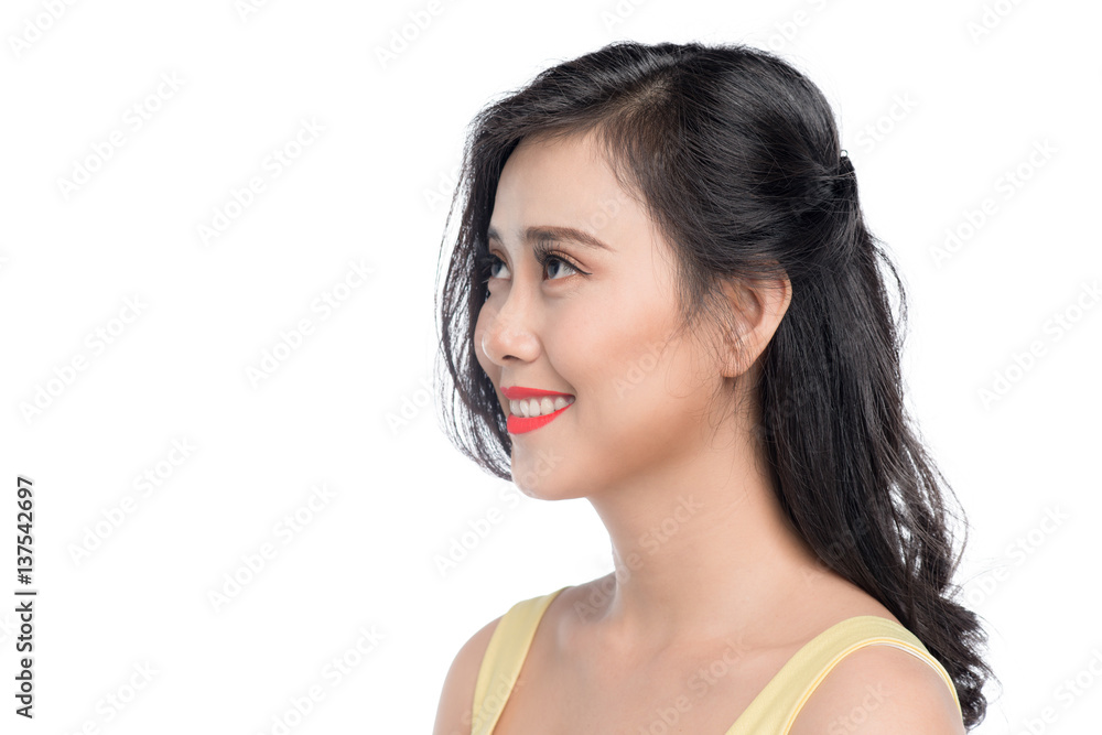 Asian young beautiful woman in yellow dress standing over white.