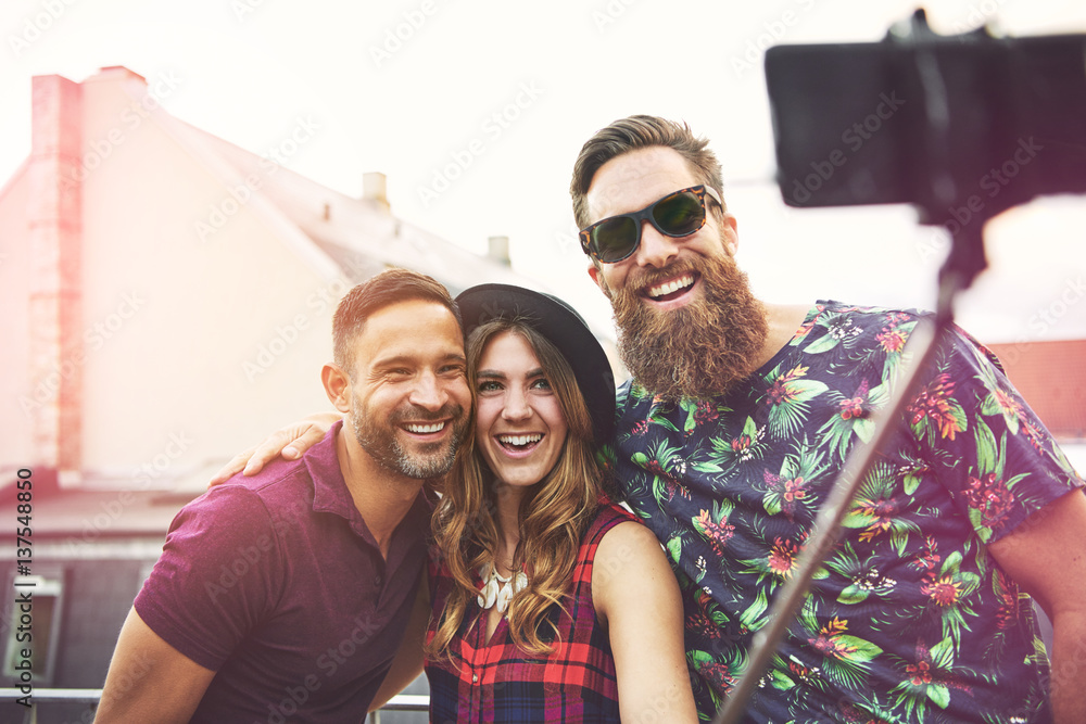 Smiling woman wearing checkered top and hat