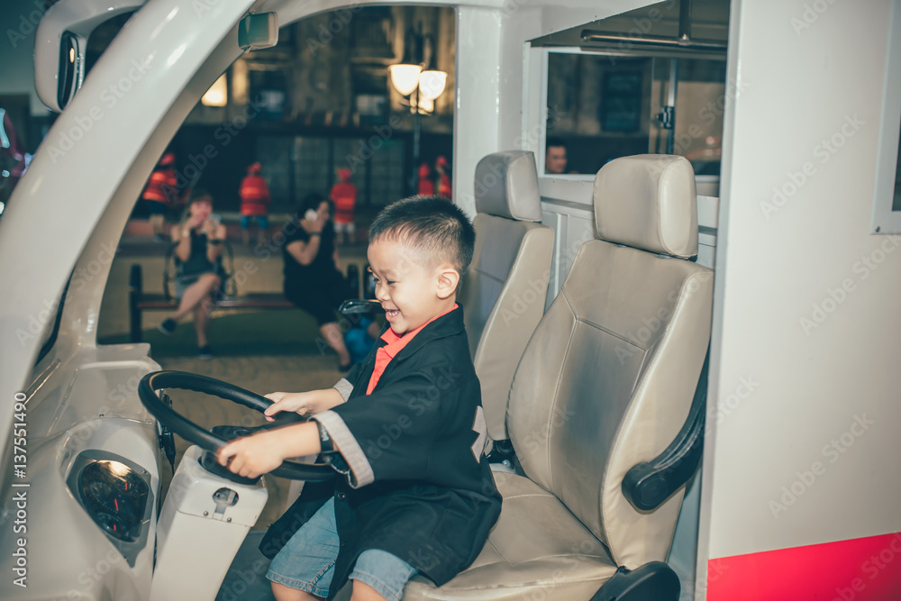 Asian boy child having fun in indoors playground