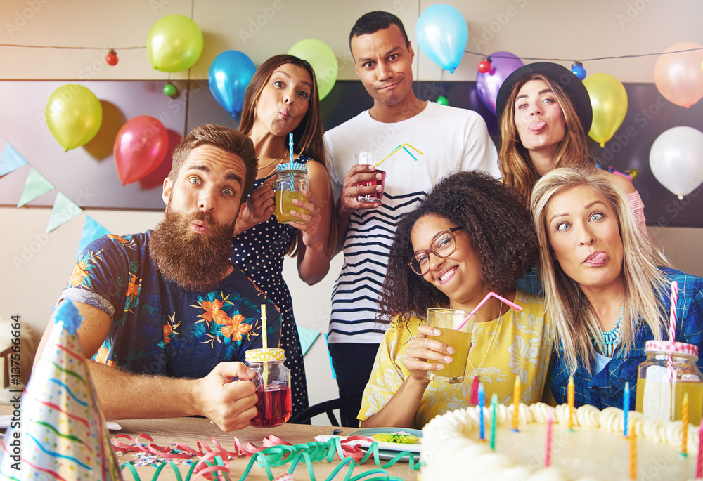 Goofy friends pulling silly faces while partying