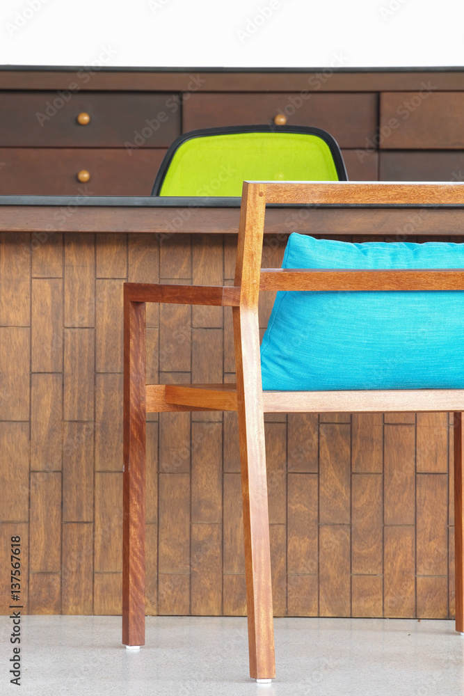 Brown wood chair with blue cushion at hotel lobby