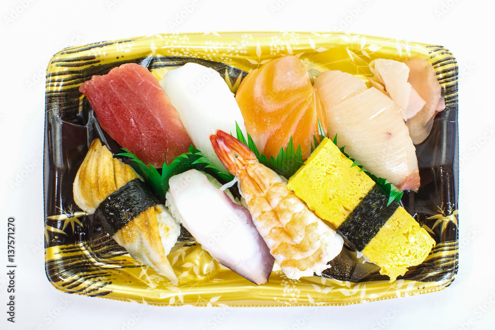 Japanese sushi raw seafood, vegetables and serving of cooked vinegared rice on white table backgroun