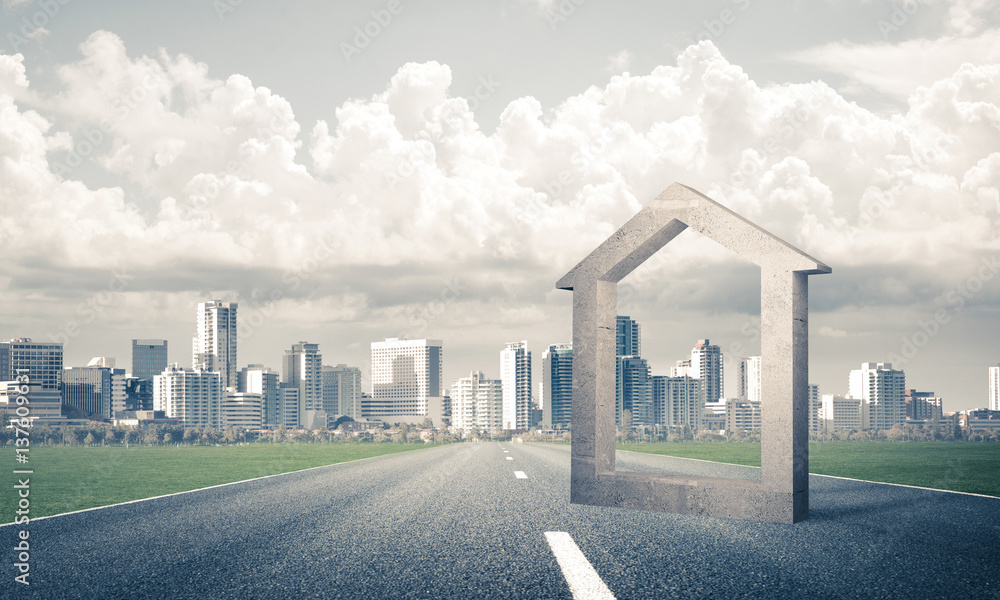 Conceptual background image of concrete home sign on asphalt roa