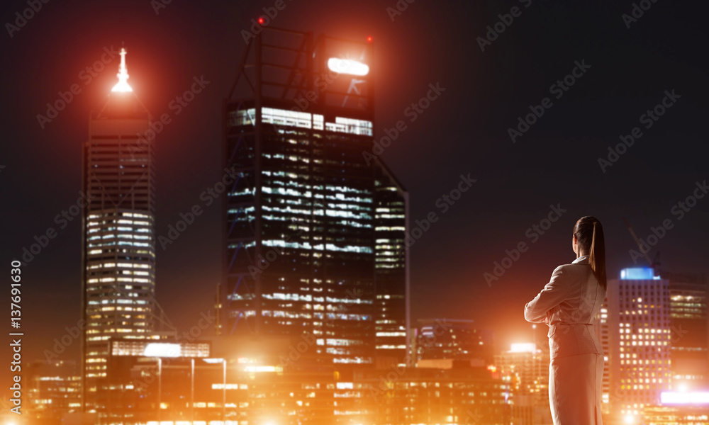 Woman looking at night city