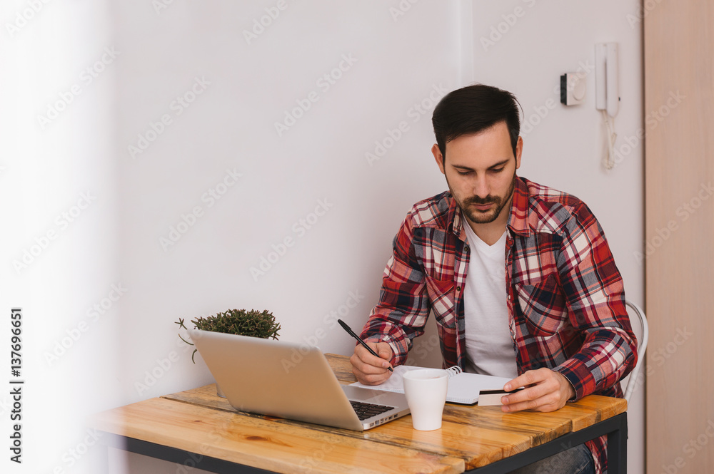 Handsome man shopping online from his home