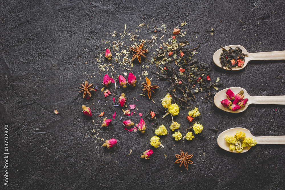 Spoons with herbs on dark background mockup top view