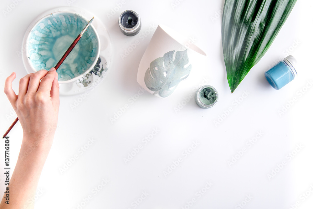 painted ceramic cup on white background top view